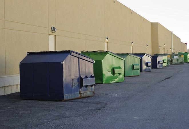 large construction waste containers in a row at a job site in Alexander, AR